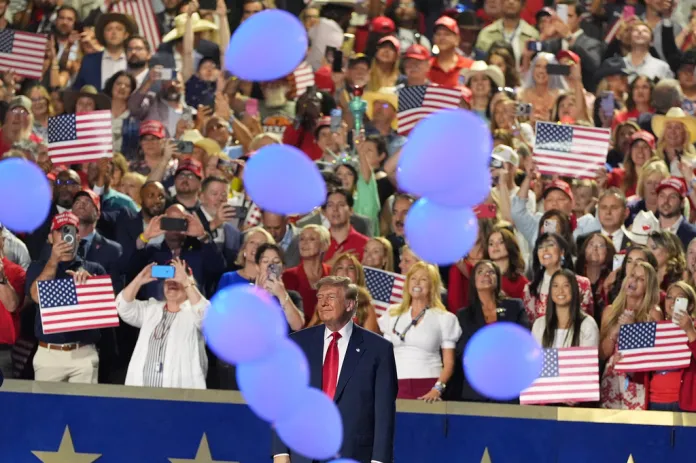President Donald Trump watches as balloons fall at the Republican convention.