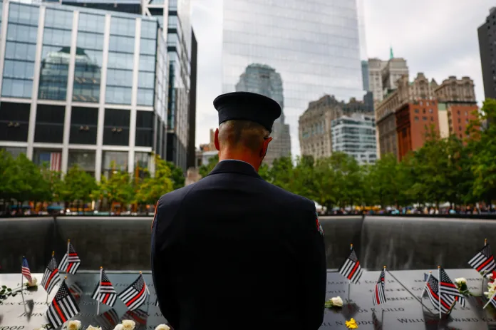 Fire Department of New York (FDNY) firefighter pays his respects at the memorial during a ceremony commemorating the 25th anniversary of the Sept. 11, 2001, attacks.
