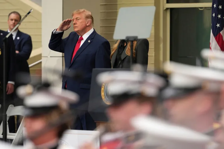 President Donald Trump salutes upon arriving at an observance ceremony on the 25th anniversary of the 9/11 attacks.