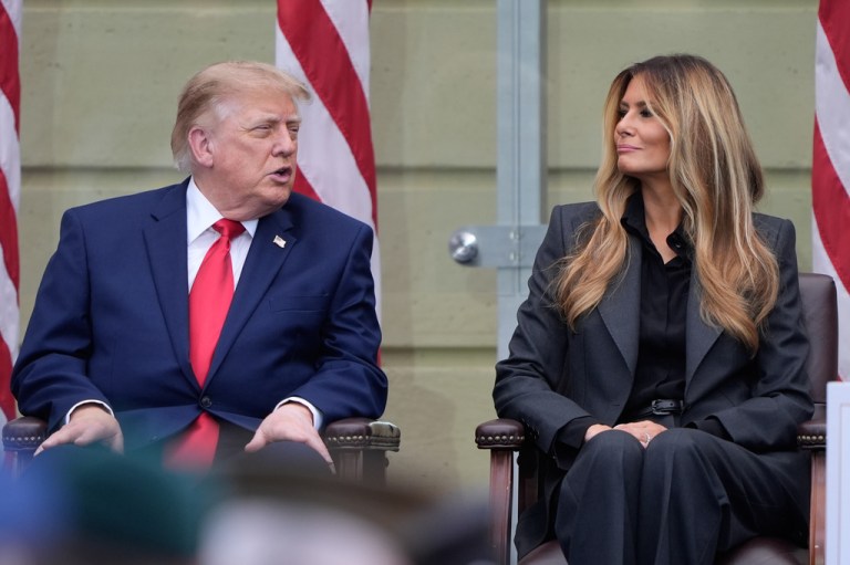 President Donald Trump talks with first lady Melania Trump.