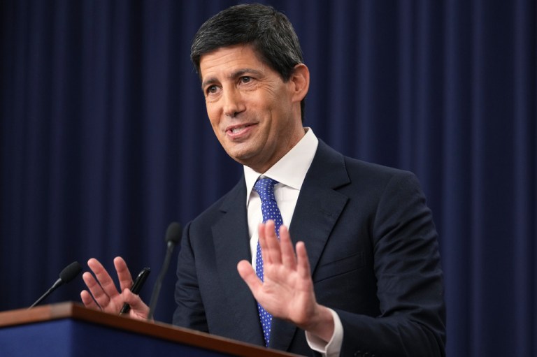 Federal Reserve Board Chairman Kevin Warsh gestures with his hands as if in defense, as he speaks during a news conference.