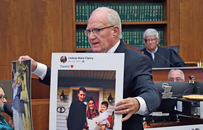 Defense attorney Kevin Reddington holds up a picture of the Clancy family before the murders during closing arguments in the Lindsay Clancy murder trial at Plymouth Superior Court on Aug. 27, 2026. (Greg Derr/The Patriot Ledger via AP)