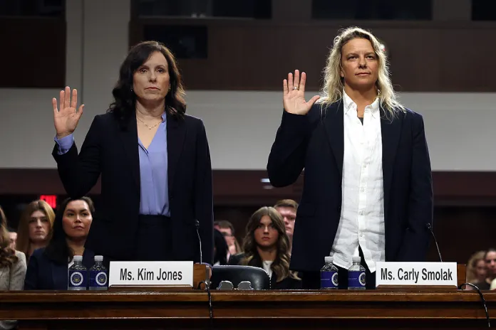 Kim Jones (L), Co-founder of the The Independent Council on Women's Sport (ICONS), and Carly Smolak (C), former goalkeeper for the San Diego Spirit women’s professional soccer team, are sworn-in before testifying before the Senate Judiciary Committee on September 23, 2026 in Washington, DC. The Committee met for a heading titled "Standing Up for Women in Sports: Ensuring Opportunity, Fairness and Safety for Female Athletes."