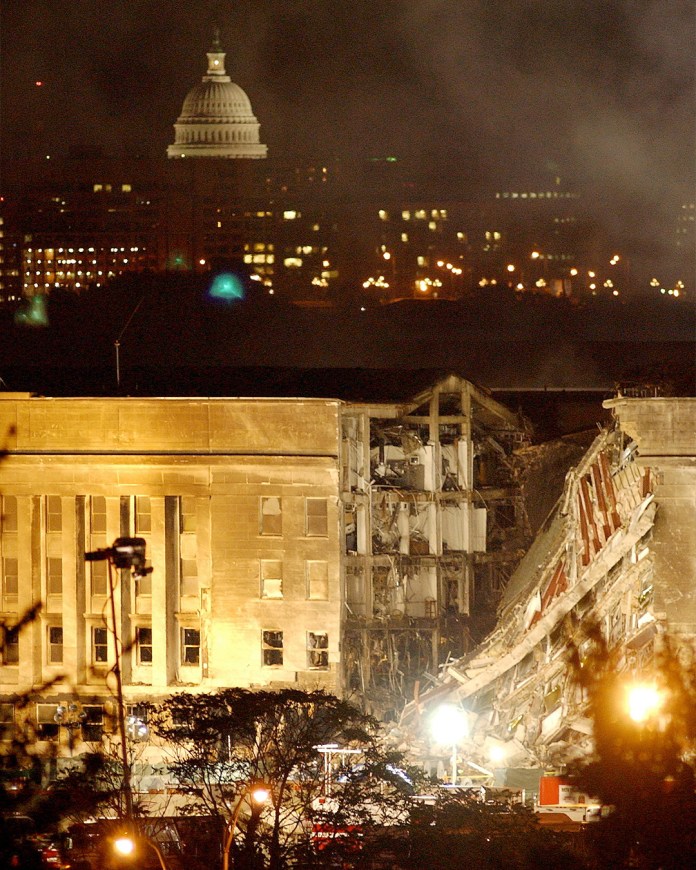 Smoke and flames rise over the Pentagon late into the night of Sept. 12, following the Sept. 11 terrorist attack of the southwest corner of the Pentagon. The building was evacuated, as were the federal buildings in the Capitol area, including the White House. (Photo by Bob Houlihan via Newscom)