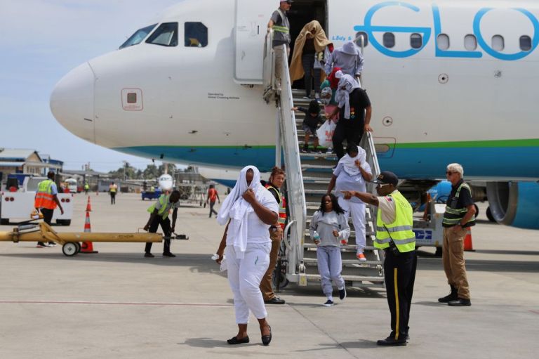 Haitians de-board a U.S. plane after being deported.