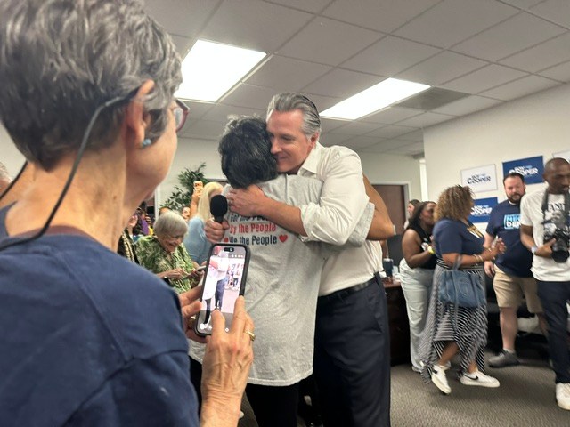 Gavin Newsom hugs a supporter in North Carolina.
