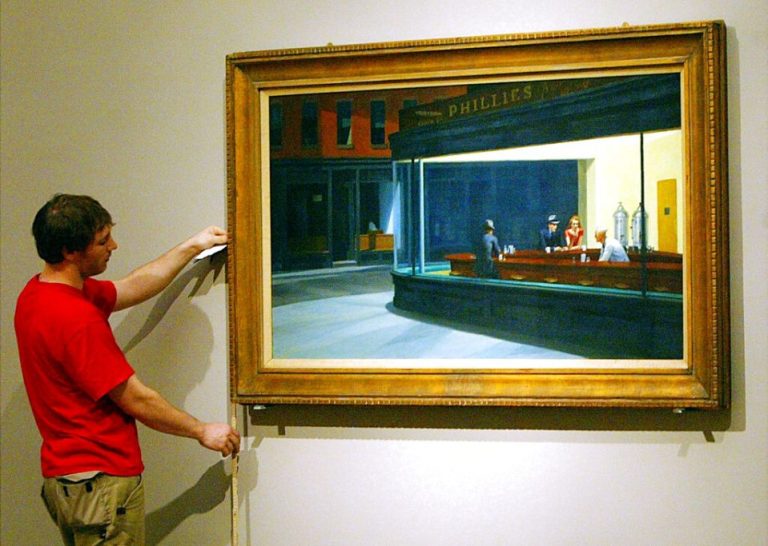A worker adjusts the paitning "Nighthawks" by famous U.S. artist Edward Hopper.