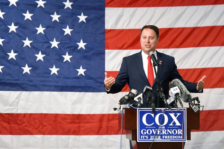 Dan Cox, Republican gubernatorial candidate in Maryland, speaks during a campaign results reception with a huge American flag spanning the whole backdrop behind him, Tuesday, Nov. 8, 2022, in Annapolis, Md.