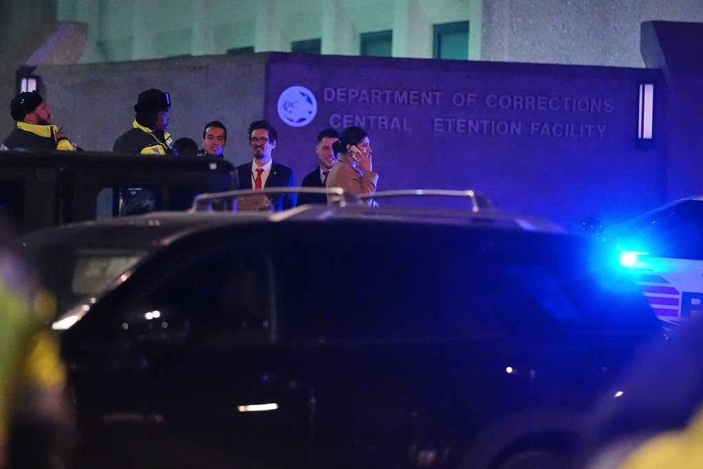 Police and media gather outside the DC Central Detention Facility.