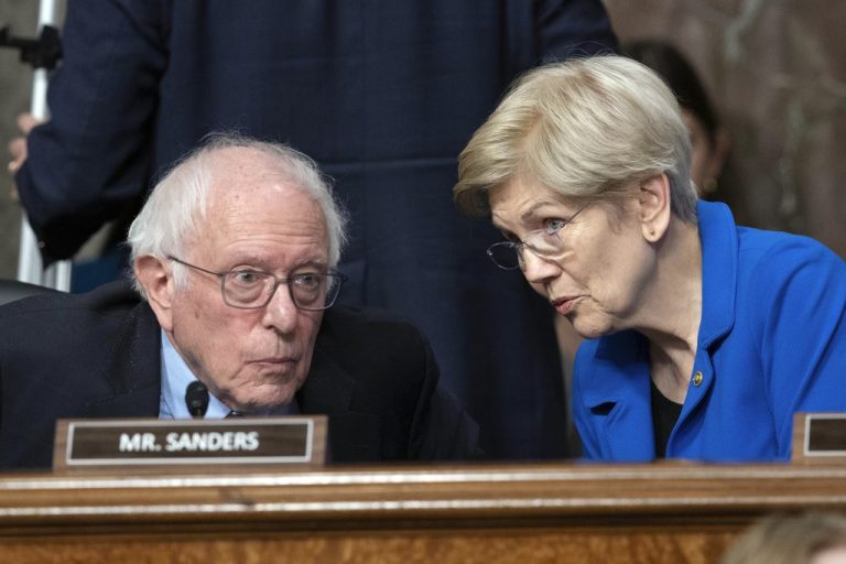 Sen. Bernie Sanders, I-Vt., speaks with Sen. Elizabeth Warren, D-Mass., as they question Robert F. Kennedy Jr., President Donald Trump's choice to be the Secretary of Health and Human Services, as he testifies before the Senate Finance Committee during his confirmation hearing, at the Capitol in Washington, Wednesday, Jan. 29, 2025.