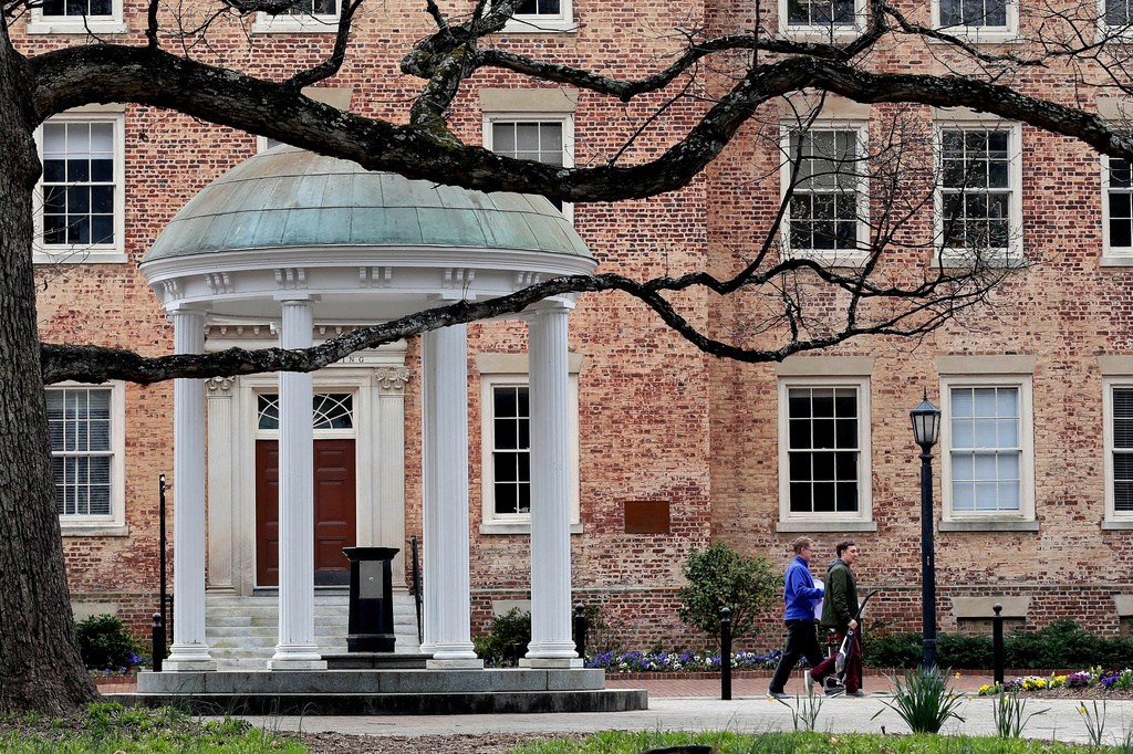 People walk through University of North Carolina campus March 18, 2020, in Chapel Hill, N.C.
