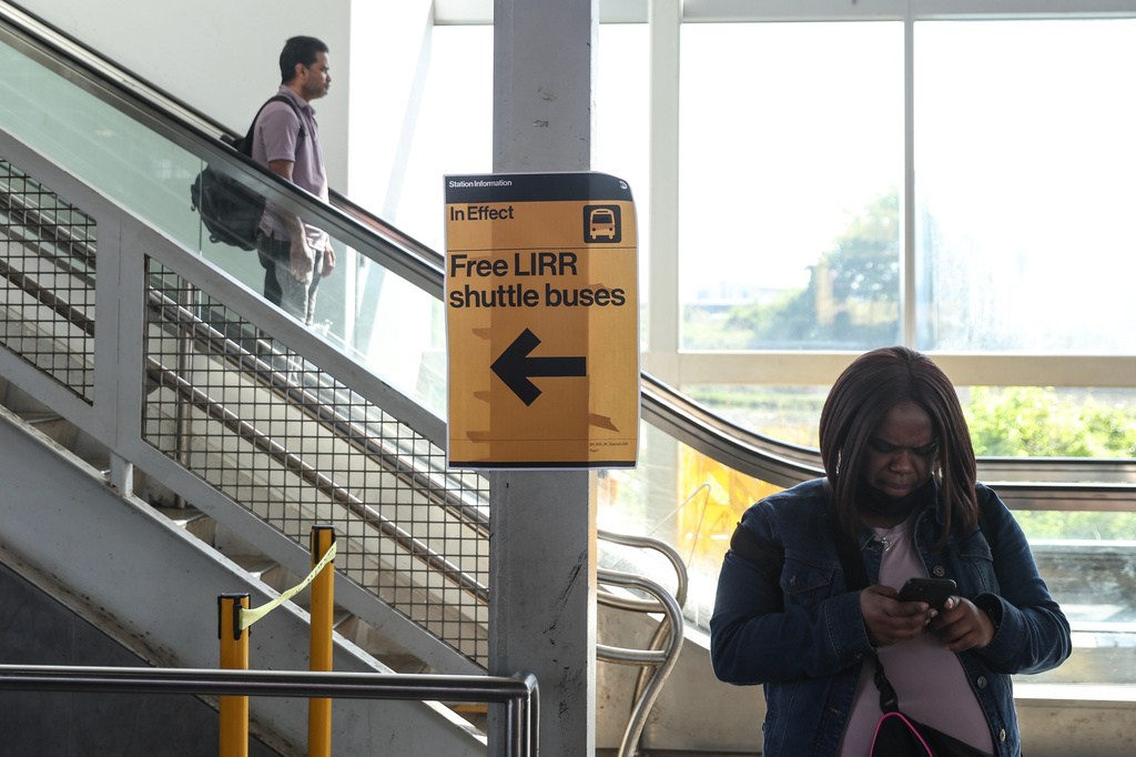 Signs for free Long Island Rail Road shuttle buses hang at the Howard Beach–JFK Airport station as Long Island Rail Road workers enter the third day of their strike, Monday, May 18, 2026, in New York.