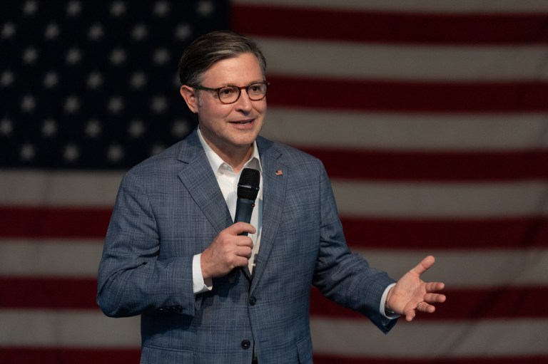 Mike Johnson speaks in front of an American flag during a campaign event.