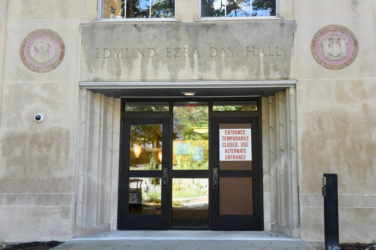 A sign is displayed on a door at Day Hall after damage and graffiti overnight was cleaned up at Cornell University, Monday, Oct. 5, 2026, in Ithaca, N.Y.