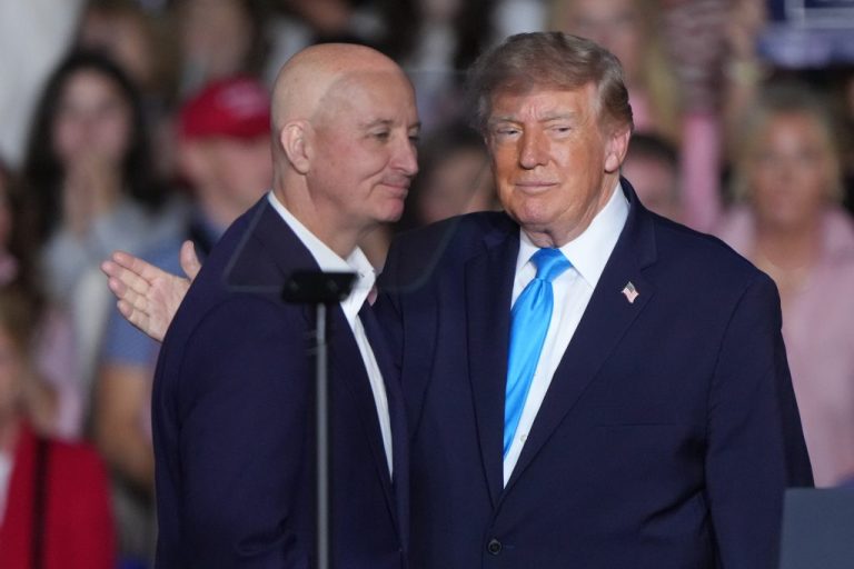 President Donald Trump greets Sen. Pete Ricketts (R-NE) at a campaign rally.