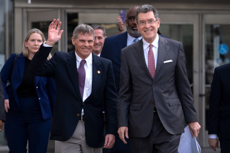 Olympic canoeist David Hearn, left, and his attorney Norm Eisen, right, leave the District of Columbia Courthouse.