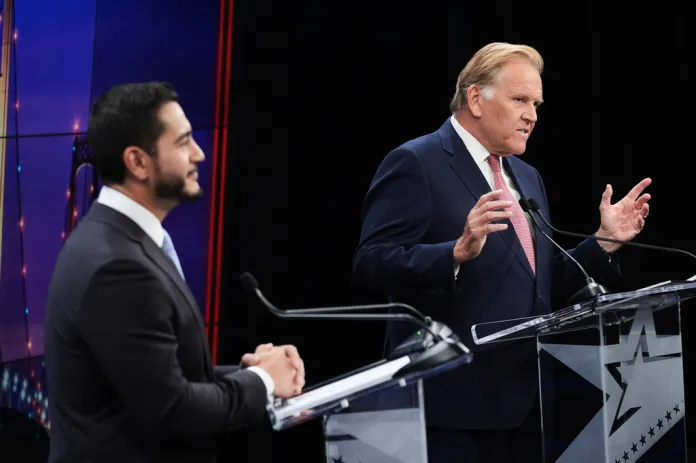 Republican nominee for U.S. Senate Mike Rogers, right, speaks during a televised debate with Democratic opponent Abdul el Sayed.