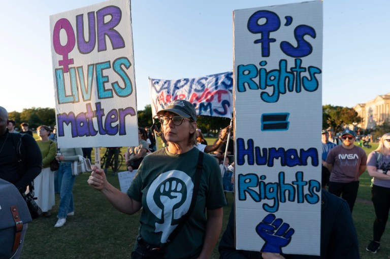 Demonstrators rally during a "Stop Sexual Violence" protest at the Washington Monument, Thursday, Oct. 8, 2026, in Washington. (AP Photo/Jose Luis Magana)