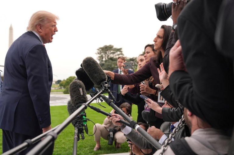 President Donald Trump speaks with reporters.