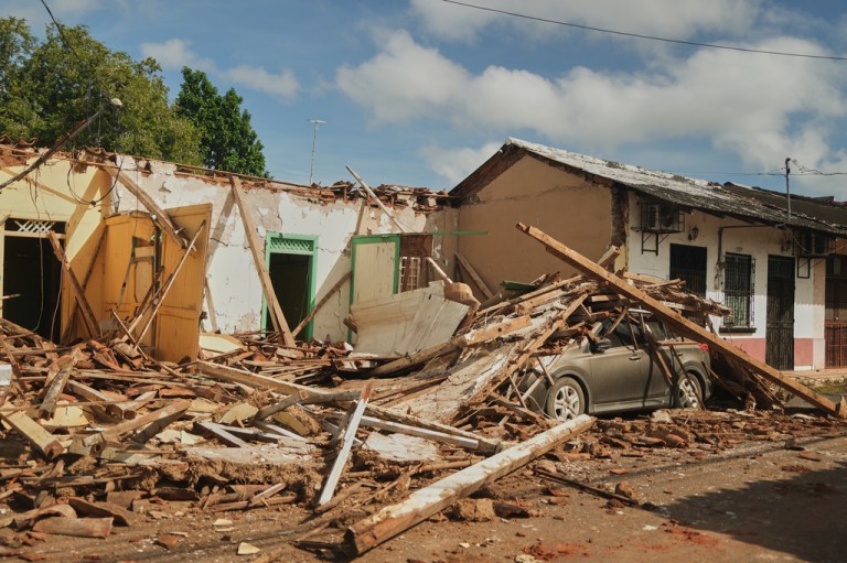 A car is covered in rubble from houses damaged by an earthquake in Villa de los Santos, Panama, Saturday, Oct. 10, 2026.