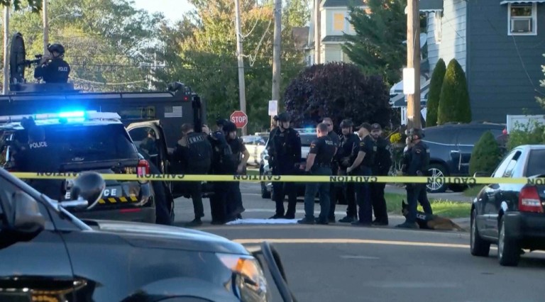 Law enforcement officers at the scene of a deadly shooting.