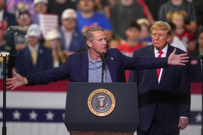 President Donald Trump listens a Sen. Jon Husted, R-Ohio, speaks at a campaign rally at the Covelli Centre, in Youngstown, Ohio, Monday, Oct. 12, 2026.