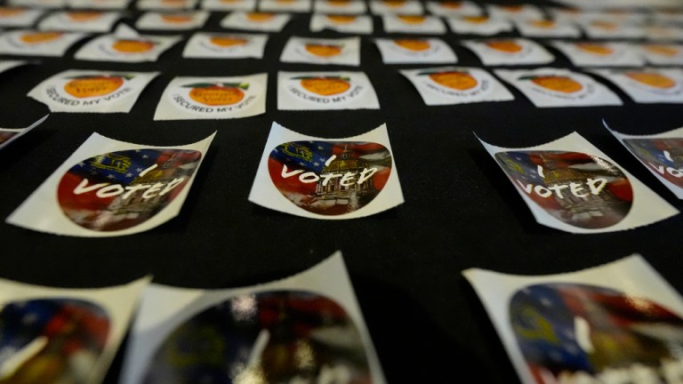 Stickers are seen at the Southwest Arts Center voting site on the first day for early voting in Georgia.