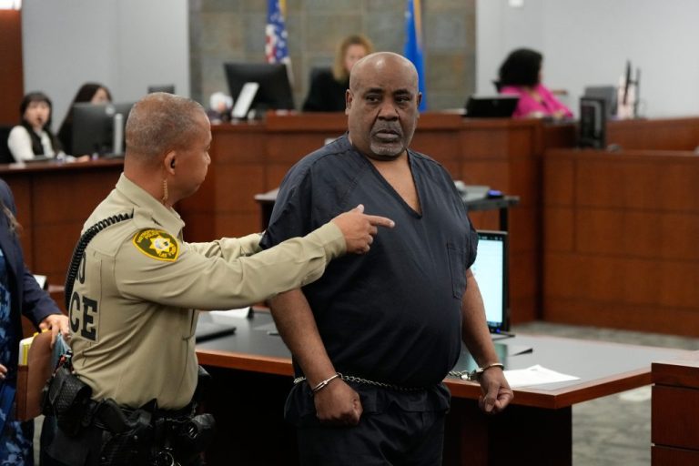 An officer addresses Duane Davis in court.