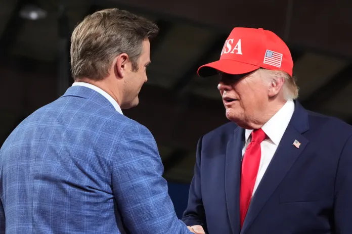 President Donald Trump greets U.S. House candidate Aaron Flint at a campaign rally at Majestic Valley Arena, Wednesday, Oct. 14, 2026, in Kalispell, Mont.
