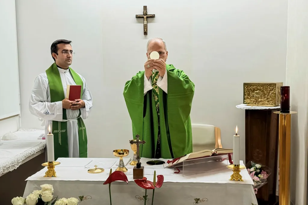 This picture, released by Vatican Media on Friday, Oct. 16, 2026, shows Pope Leo XIV, flanked by his personal secretary, Monsignor Edgard Iván Rimaycuna Inga, left, celebrating Mass at the Agostino Gemelli Polyclinic in Rome, where he is recovering after having cancer removed from his right lung.