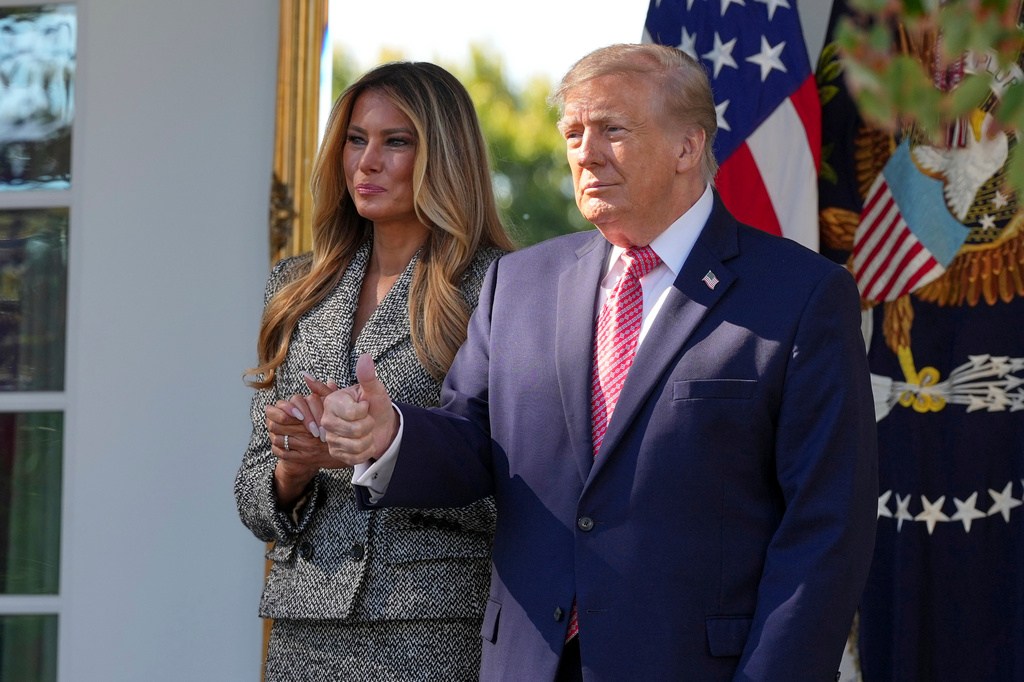 President Donald Trump, right, and first lady Melania Trump, left, gesture to the crowd