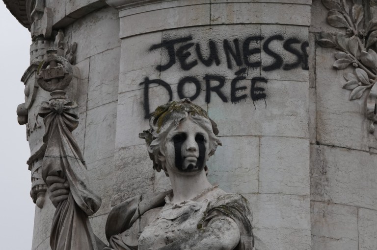 Tagging reading "The golden youth" on the statue of Equality at the Republique square, after a quiet night Monday under curfew, the first since weekend protests over the cost of living turned into rioting and looting across France, in Paris, Tuesday, Oct. 20, 2026.