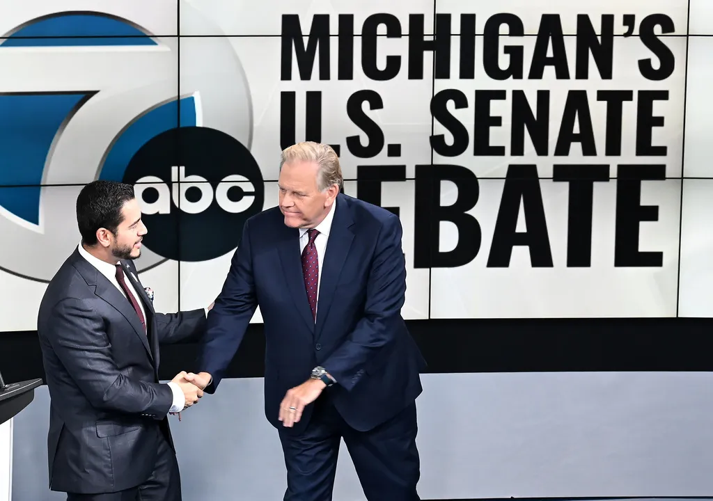 U.S. Senate candidates Democrat Abdul El-Sayed, left, and Republican Mike Rogers shake hands before the debate on Wednesday, Oct. 21, 2026 at WXYZ Channel 7.
