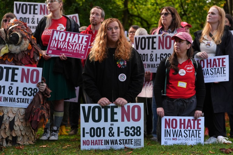 Sam Friedman, center, looks on during a "No Hate in WA State" rally