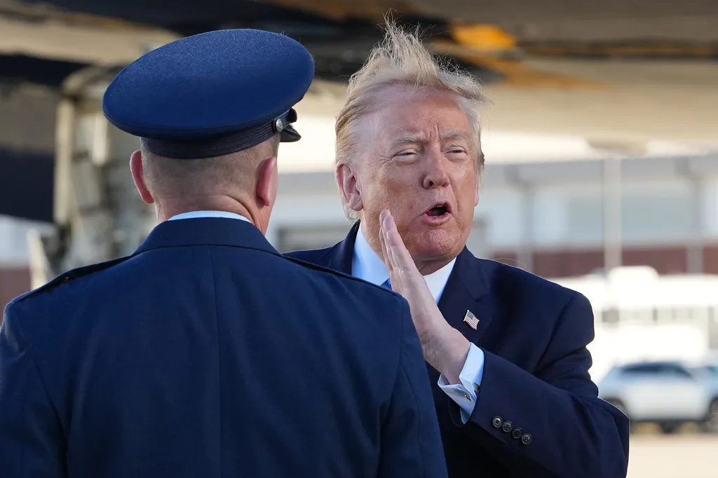 Trump opens Mississippi rally by tossing out MAGA hats to the crowd