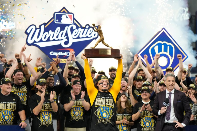 Milwaukee Brewers catcher William Contreras holds the MVP trophy.