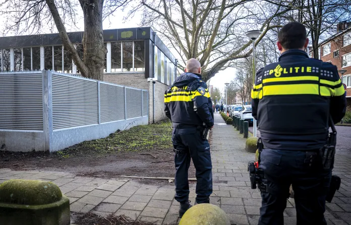 Dutch police officers stand guard near a Jewish school in Amsterdam on March 16 following its reopening two days after an attack on the institution. (ANP/AFP via Getty Images)