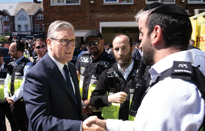 British Prime Minister Keir Starmer, left, meets first responders from Shomrim North West London during a visit to Golders Green, on April 30, following an attack in which two Jewish men were stabbed in broad daylight. (Stefan Rousseau/Pool via AP)