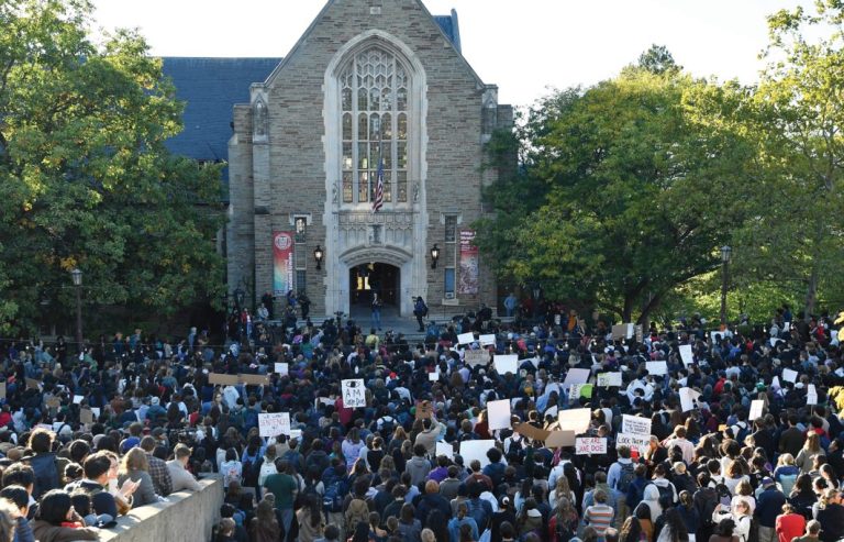 Demonstrators on Oct. 5 listen to a speaker during a protest against Cornell University’s handling of the 2024 fraternity-house gang rape allegations.