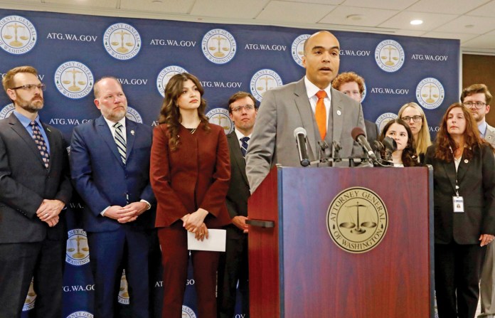 Surrounded by other Washington state officials in Seattle, Attorney General Nick Brown announces a federal lawsuit
challenging President Donald Trump’s executive order attempting to overhaul elections in the U.S., April 4, 2025. (Manuel Valdes/AP)