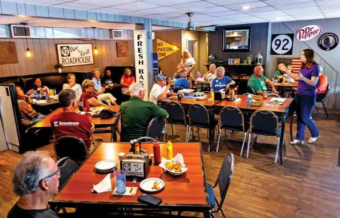 Democratic candidate for Congress Christina Bohannan, at far right, speaks to a county-level organization of Democrats in Columbus Junction, Iowa, Aug. 16, 2026. (Joseph Cress/AP)