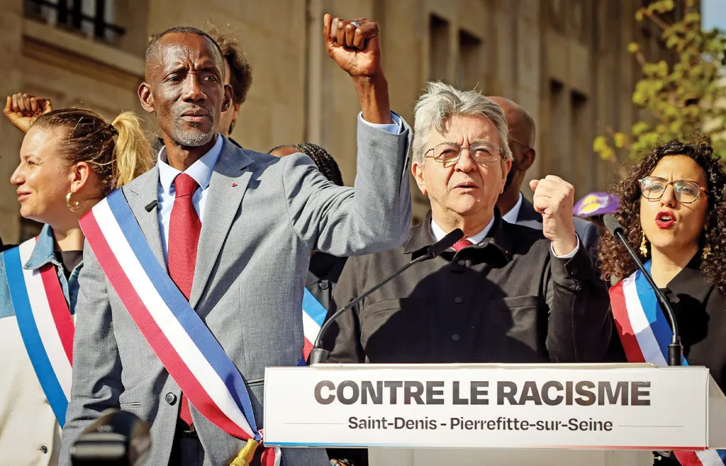 At right, Jean-Luc Melenchon, leader of the far-left France Unbowed party, at a rally against racism in Saint-Denis, France, with Bally Bagayoko, left, the newly elected mayor of Saint-Denis and member of the far-left party La France Insoumise, April 4, 2026. (Thomas Padilla/AP)