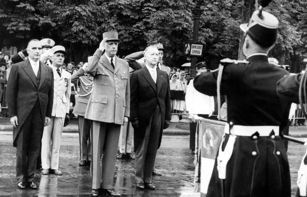 French President Charles de Gaulle, center, with Premier Georges Pompidou, left, and Defence Minister Pierre Messmer, right, at Bastille Day ceremony in Paris, July 14, 1962. (Associated Press)