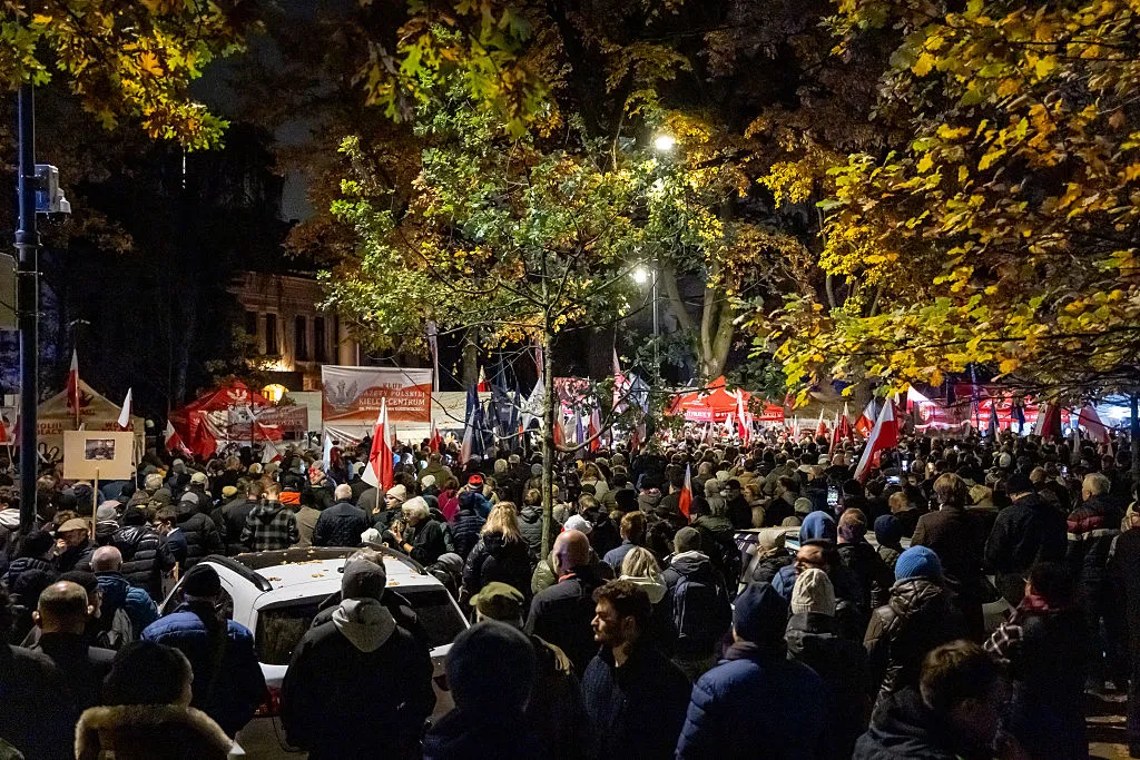 Protesters gather outside the headquarters of Poland's Constitutional Court after police blocked access to the building in Warsaw, Poland on October 30, 2026. Poland's President Karol Nawrocki called off a visit to Africa in mid-flight as riot police deployed around the country's constitutional court on October 30 following the suspension of its chief justice in a battle between the centrist government and the nationalist right. Dozens of police guarded the entrance to the court as followers of the opposition right-wing Law and Justice party (PiS) protested the ousting of constitutional court president Bogdan Swieczkowski.