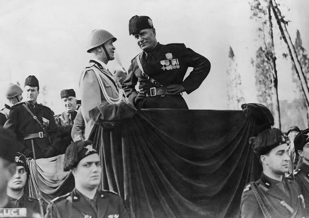 Italian fascist dictator Benito Mussolini (1883 - 1945) at a march past of athletes in the Via Del Circo Massimo, Rome, 28th October 1934. (Photo by GPA/Hulton Archive/Getty Images)