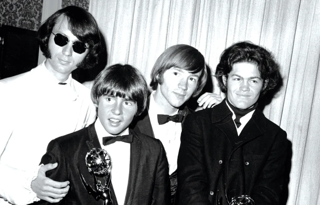 The Monkees (from left, Mike Nesmith, Davy Jones, Peter Tork, and Micky Dolenz) pose with their Emmy award on June 4, 1967. They won for best comedy series and best comedy direction for their television program The Monkees. (AP Photo)