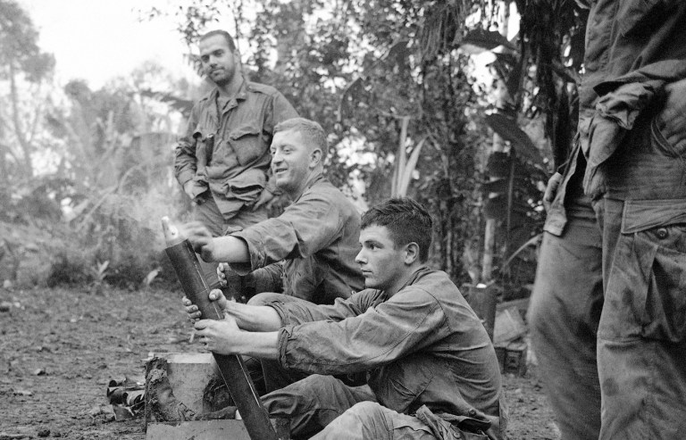 U.S. Marines flinch as shell booms from the tube of their mortar on a sweeping operation south of Da Nang, South Vietnam on Dec. 1, 1966, in an area believed to be under strong Vietcong influence. While the mortar is capable of being hand-held, it is normally placed on a heavy base plate to stand on its own. (Dang Van Phuoc/AP Photo)