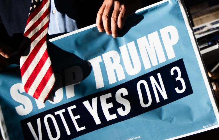 A campaign staffer for Gov. Wes Moore (D-MD) sets up signs outside the Silver Spring Civic Building on the first day of early voting in the 2026 midterm race on Oct. 22, 2026, in Silver Spring, Maryland. (Allison Robbert/AP)
