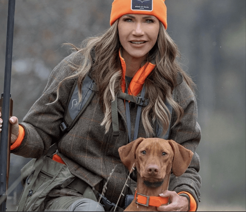 Kristi Noem poses with her dog.