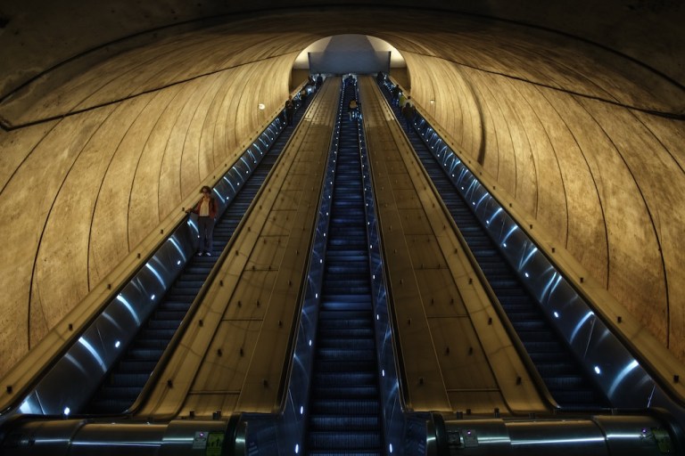 Commuters enter and exit the Bethesda Metro station in Bethesda, Maryland, Thursday, May 21, 2026. (AP Photo/Jon Orbach)